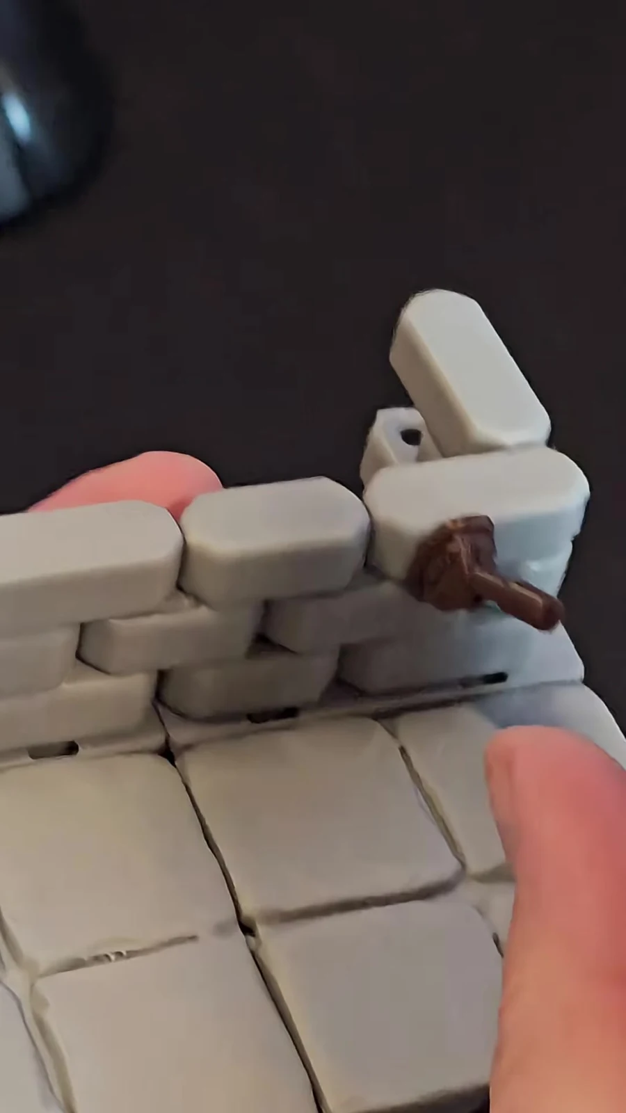 A removable brown accessory attached to a real stone wall